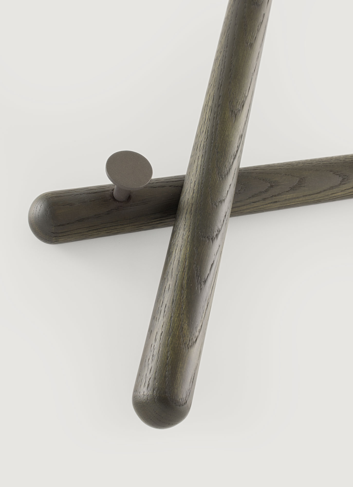 Close-up of Mikado coat rack showing sleek lines and pegs.