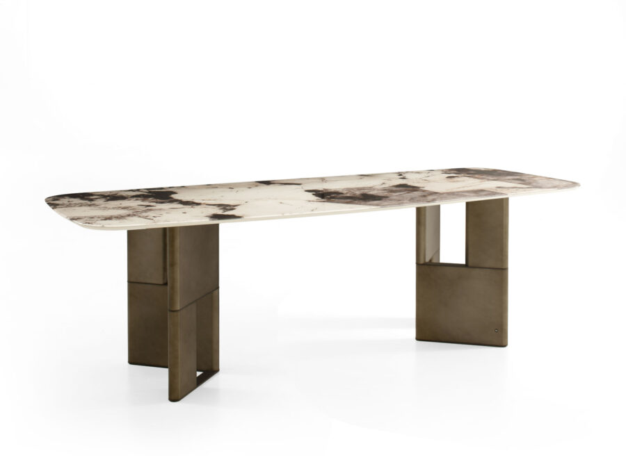 A striking dining table with oxidized bronze lacquered legs, a shaped metal insert, and a printed glass top, embodying the playful essence of "Tetris."